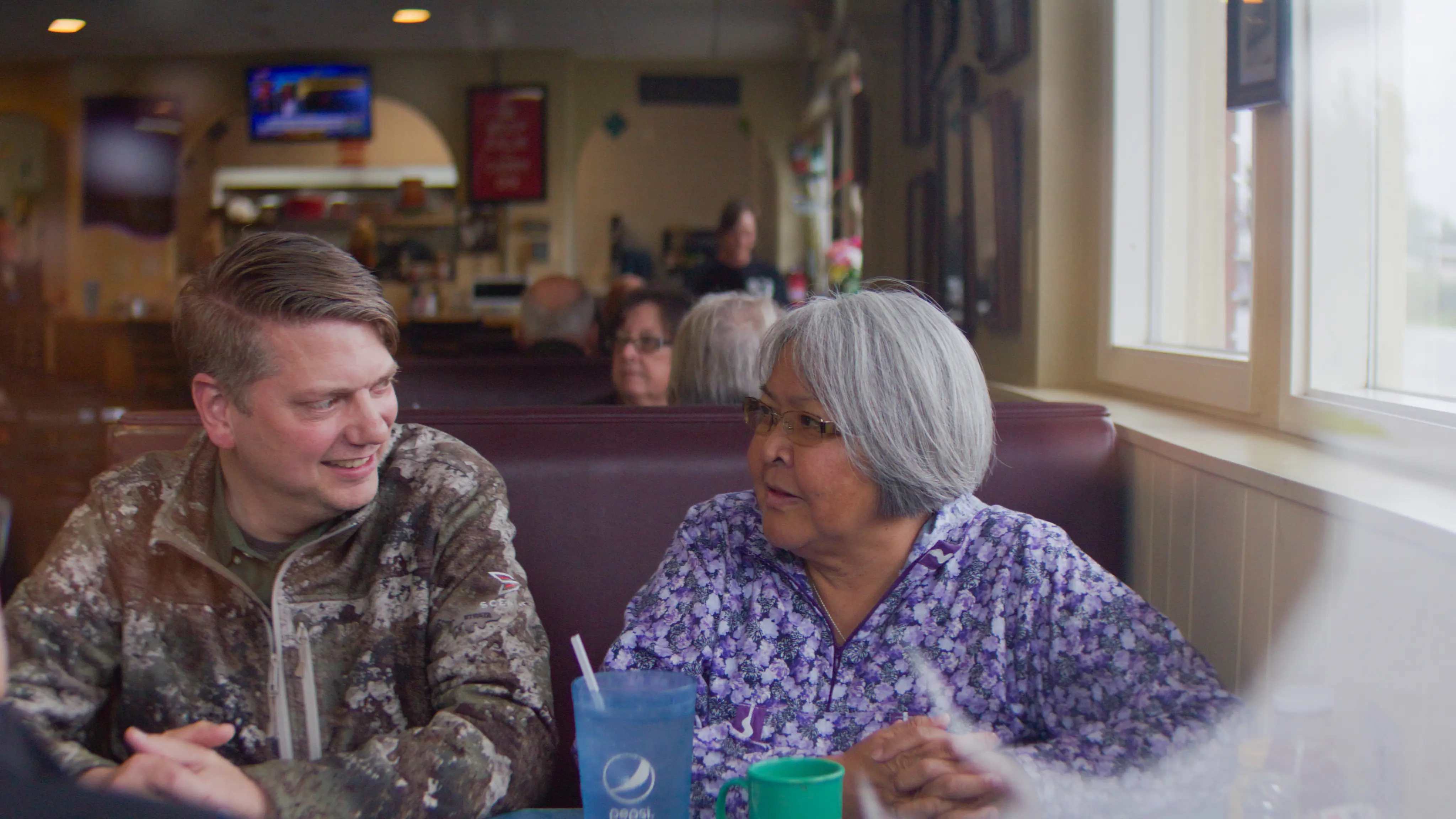 Congressman Begich talking with an Alaskan at a diner