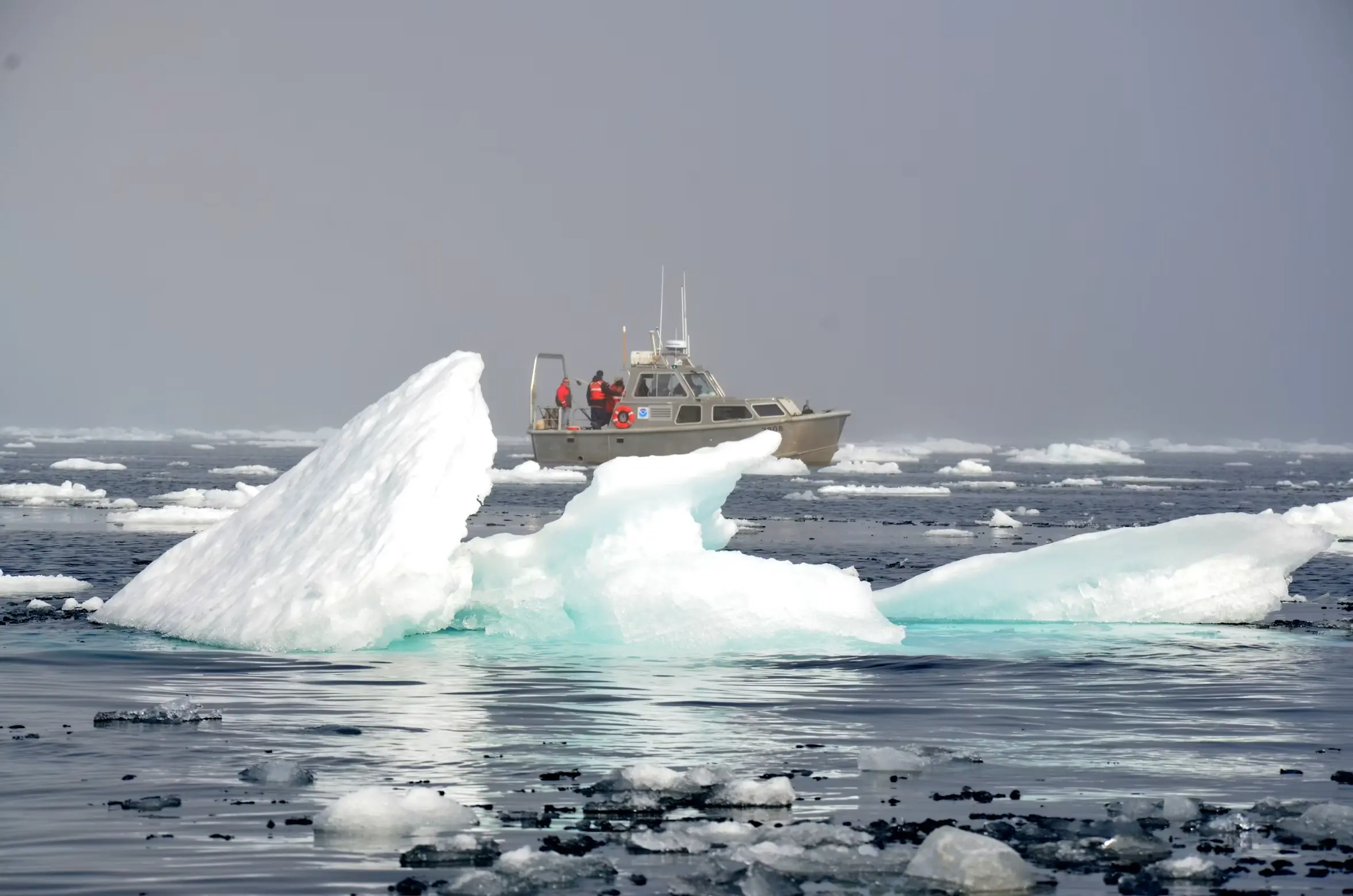 A patrol boat among floating sea ice