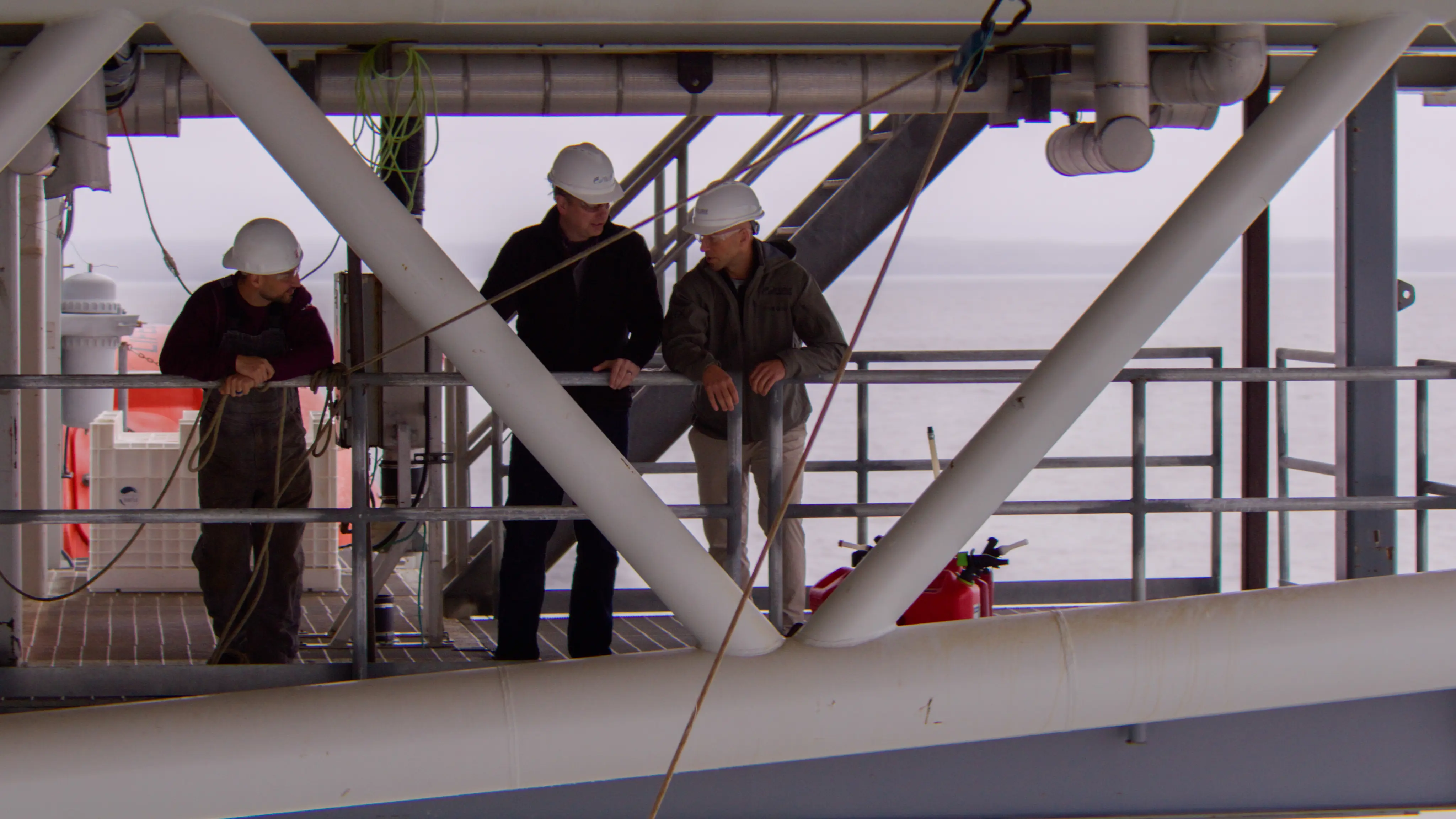Workers in hard hats on an industrial platform