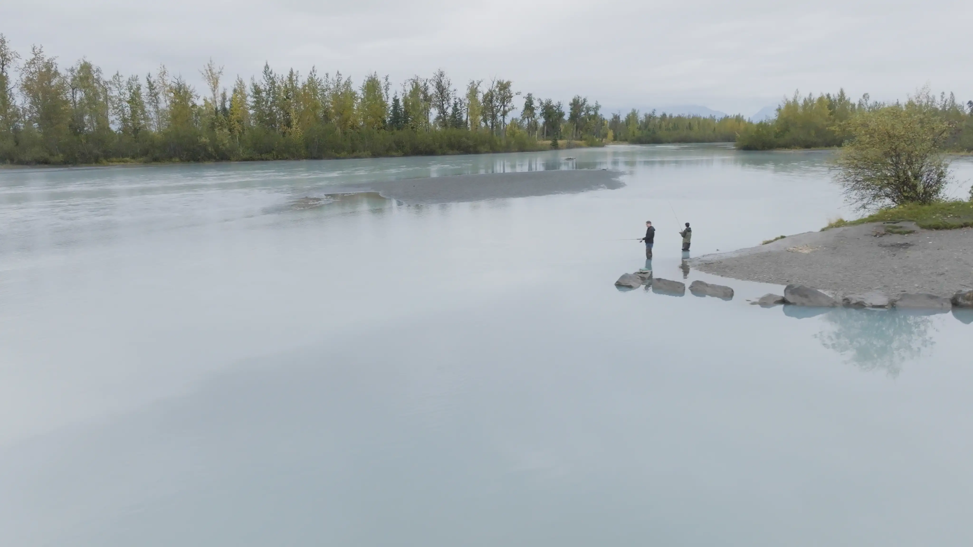 Alaskans fishing along a glacial river